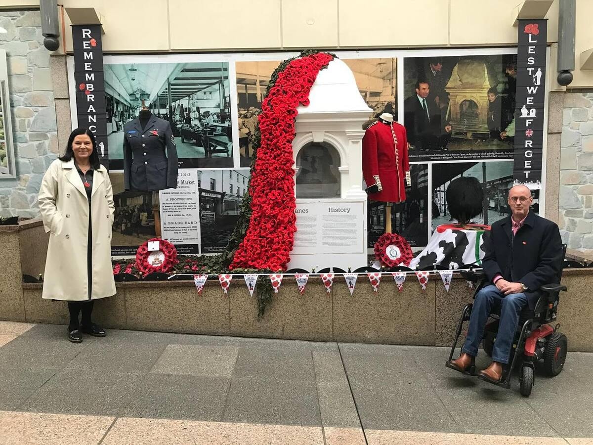 the streets of the city are decorated with red poppy flowers on Remembrance Day