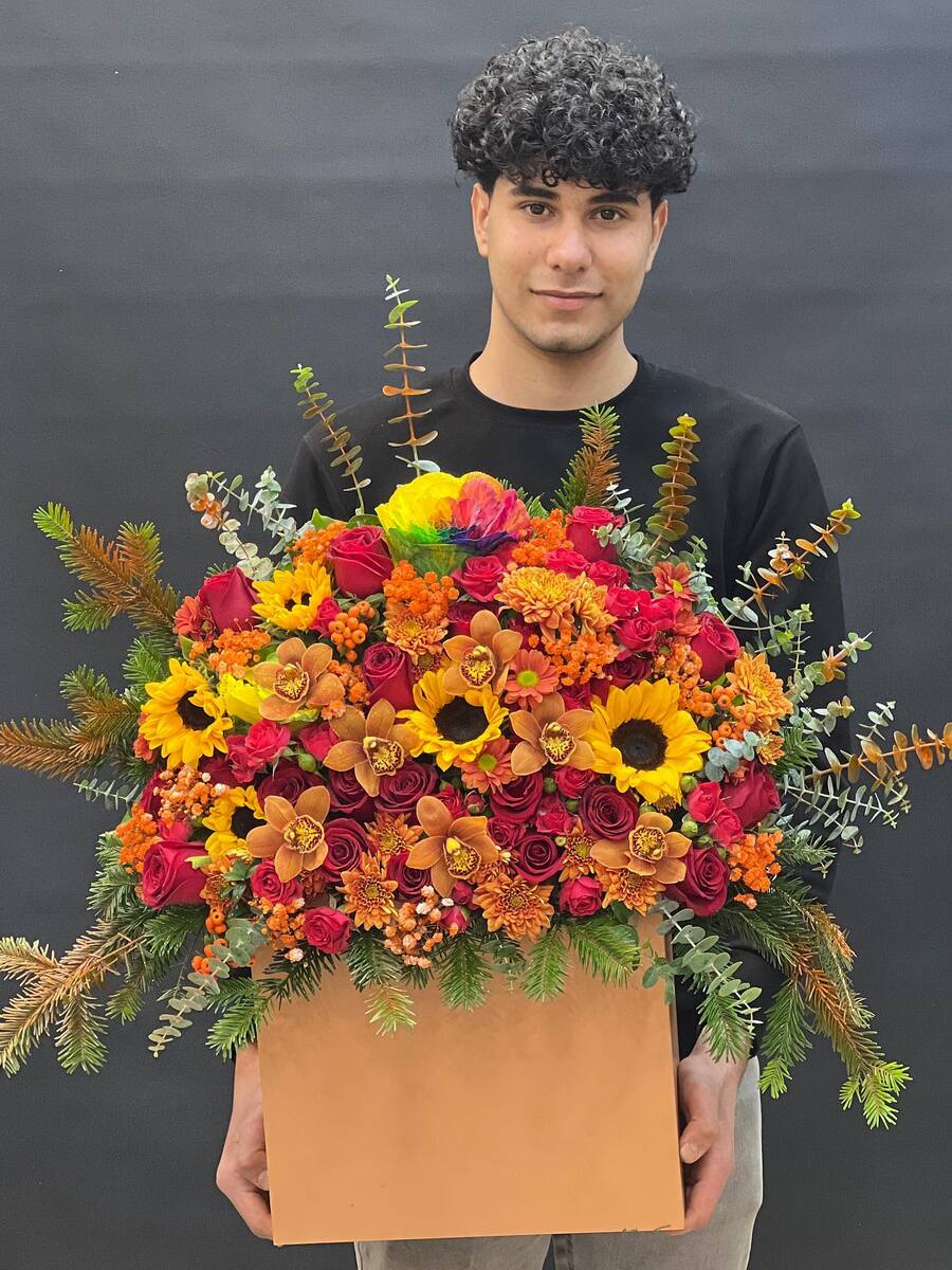 Men holding red flower bouquet