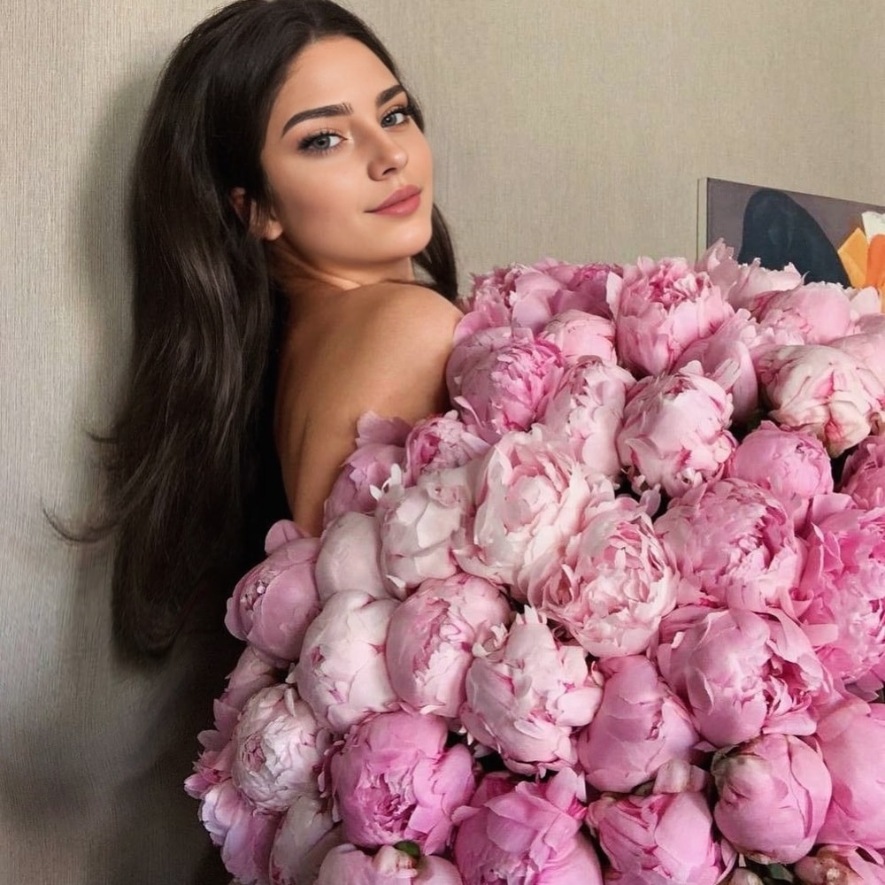 woman holding pink peonies