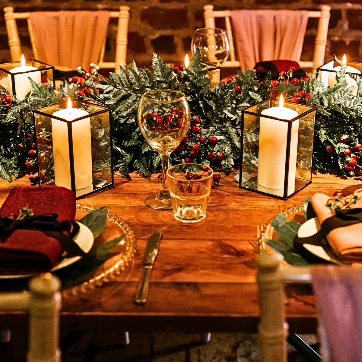 Reception table draped with sage green runner with leathery fronds and Chico leafs pairing beautifully with hypericums