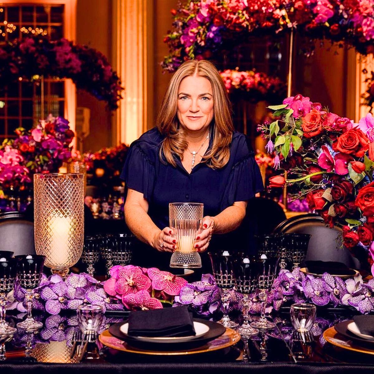 Sarah Haywood decorating a table with orchids