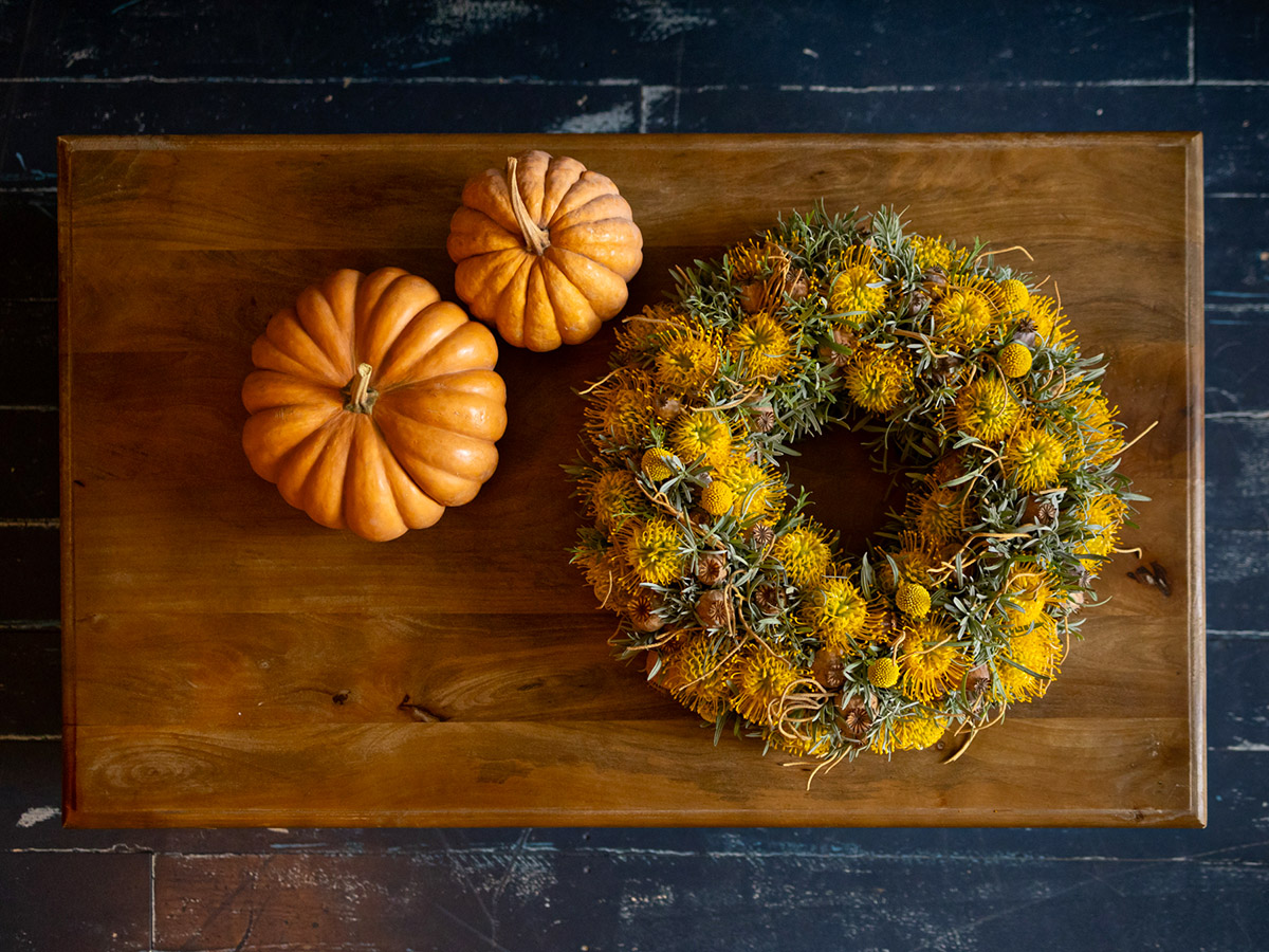 Krisztian Kover Yellow Craspedia and Nutans wreath on table