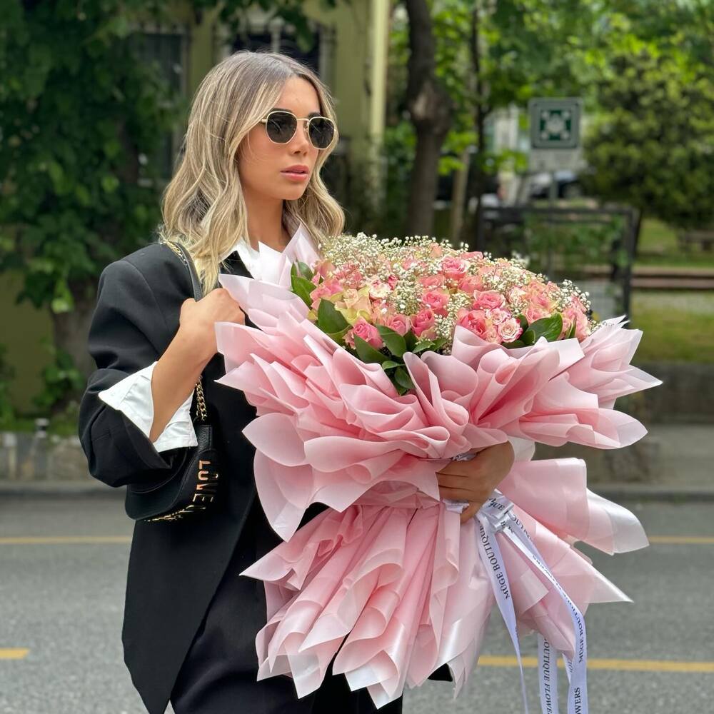 beautiful lady with large bouquet of flowers