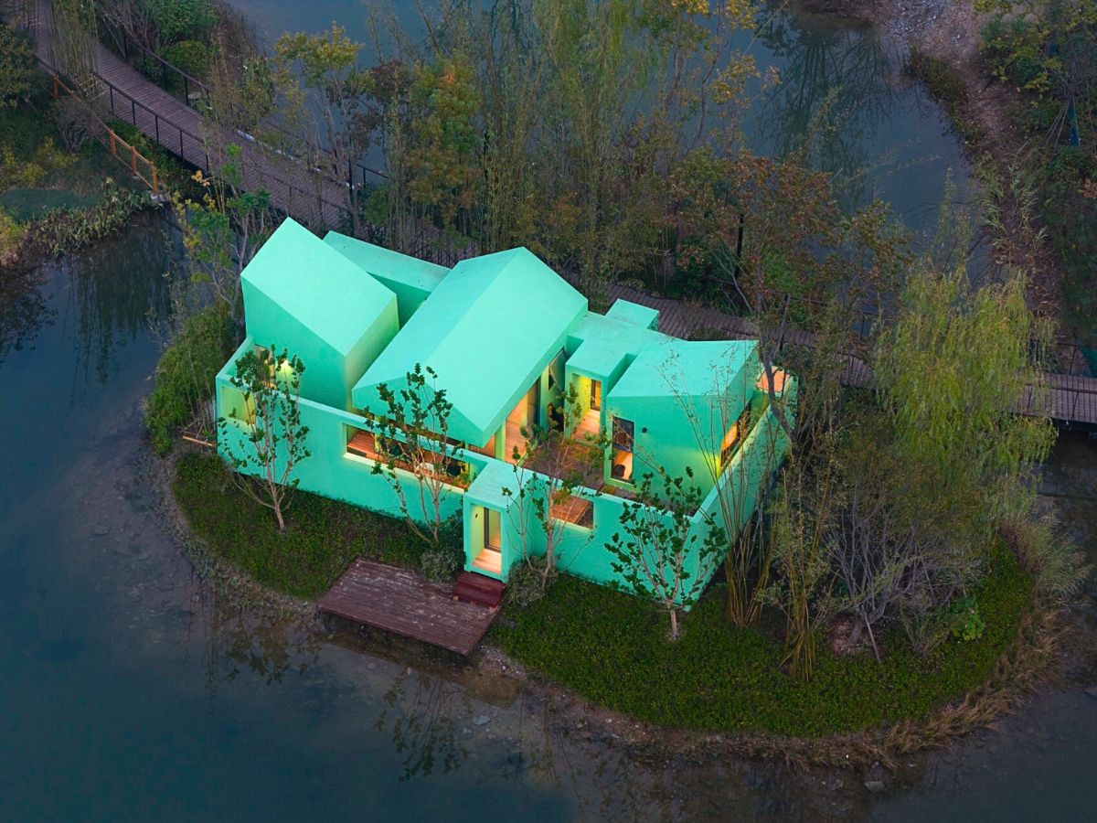 Night view of the pastel green cabin in nature