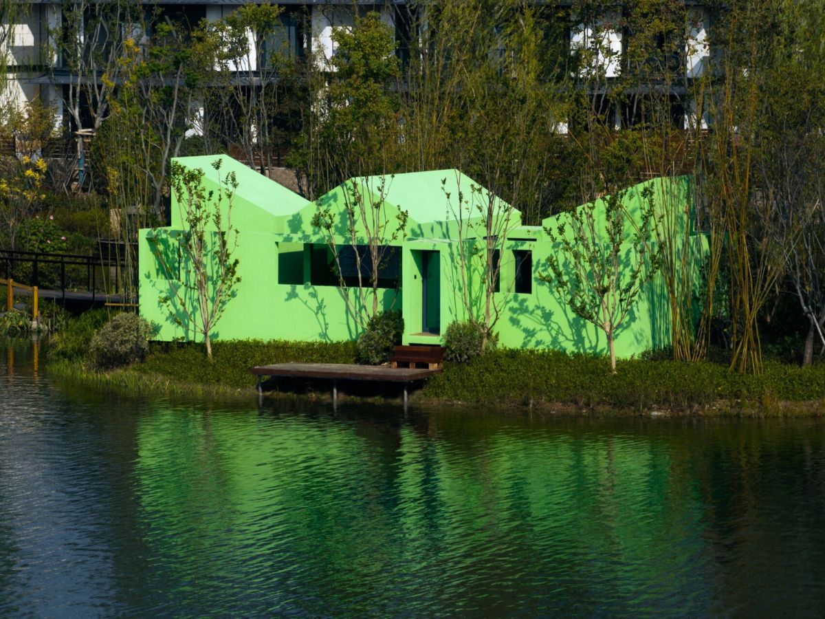 Cabin in front of a lake by Wiki World