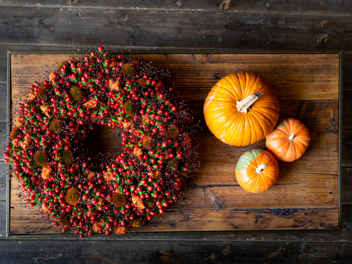 Krisztian Kover berries wreath and pumpkins on table