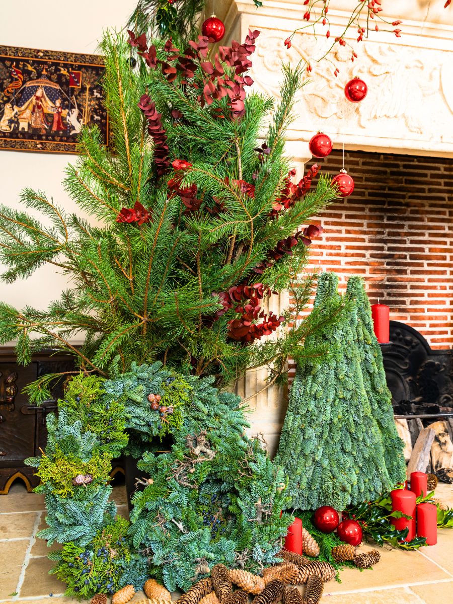 Wreaths trees and greens with hanging red decor