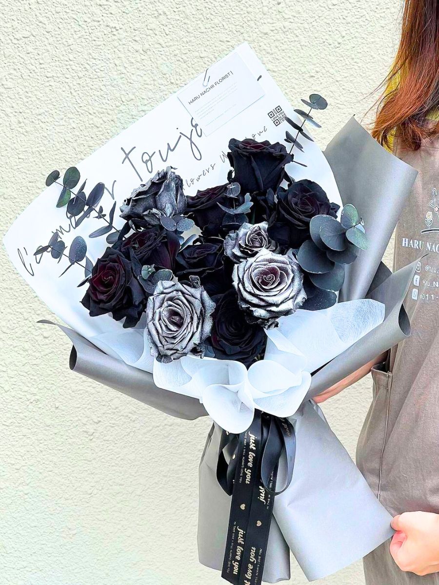 A bouquet featuring tinred black roses and silver roses