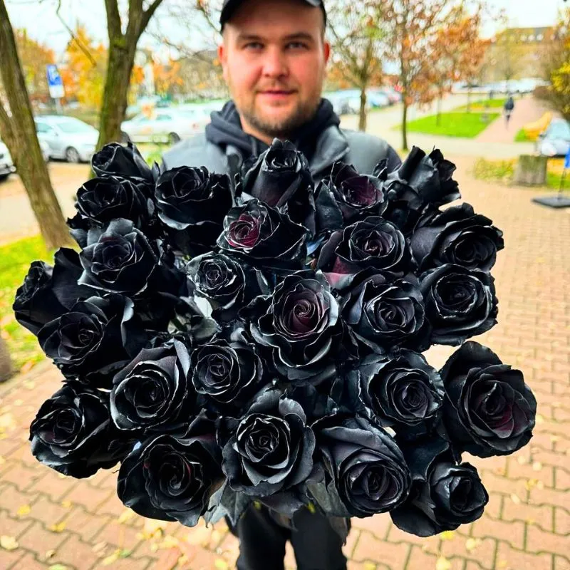 Man with black rose bouquet featured