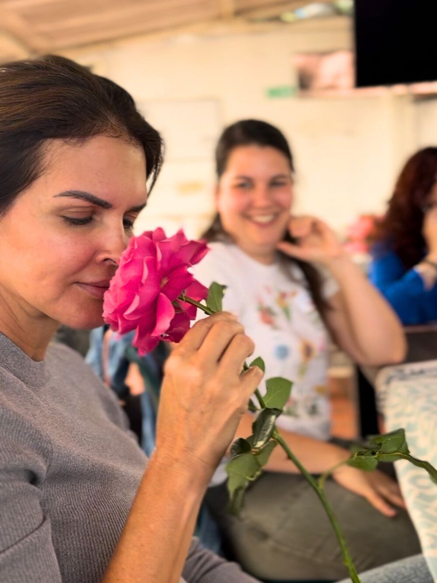 Visitor smelling a garden rose