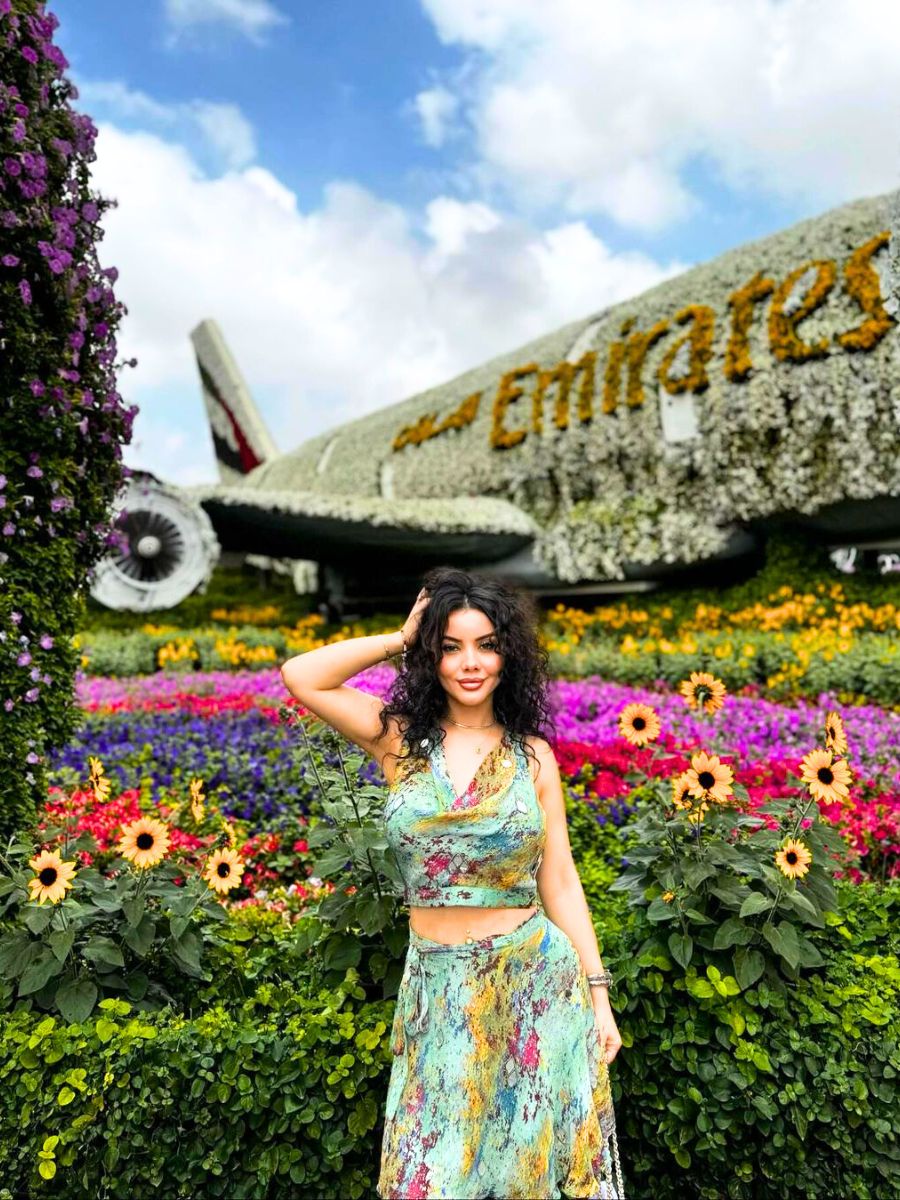 Girl posing next to the Emirates floral installation