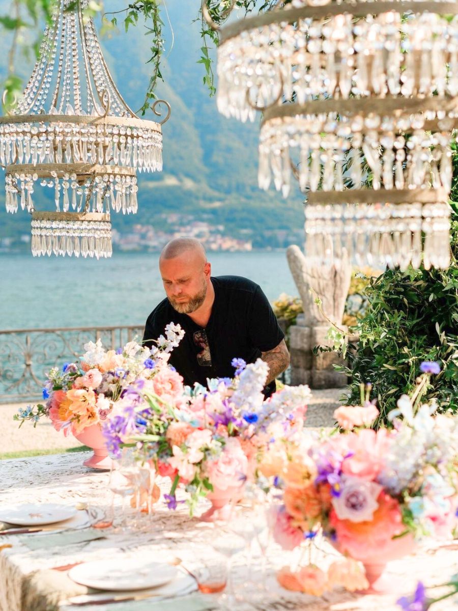 Larry Walshe arranging flowers for a wedding tablecenter