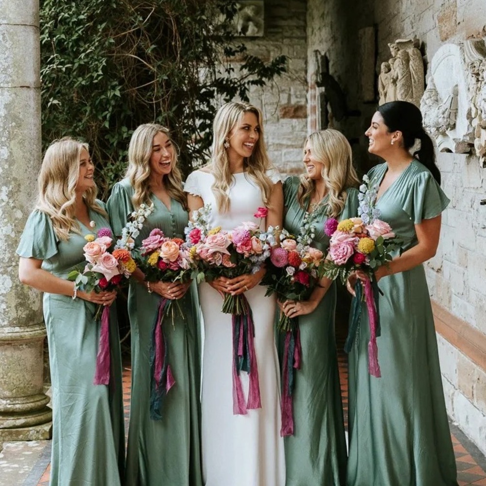 group of bride friends with flower bouquet