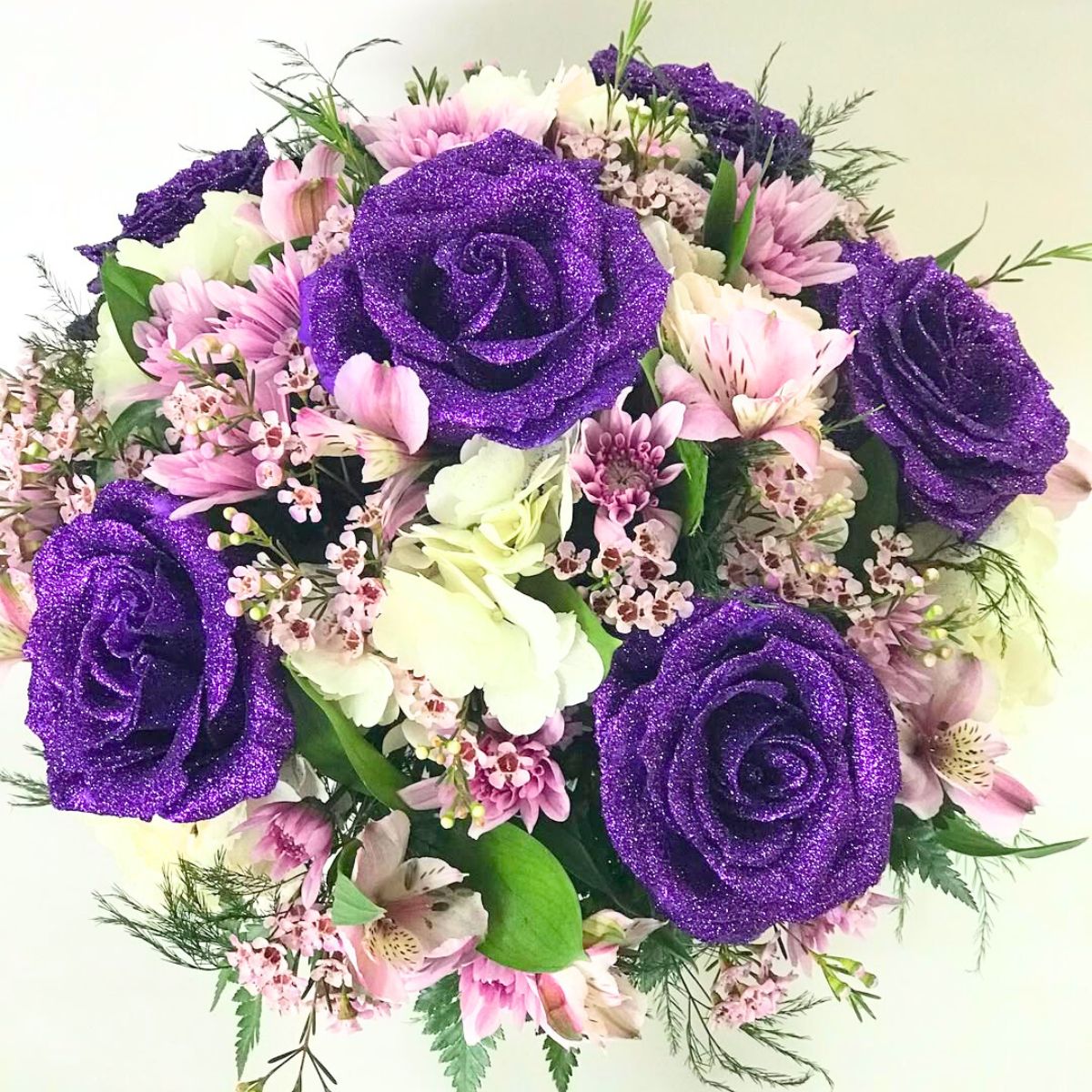 Purple glitter roses in an arrangement