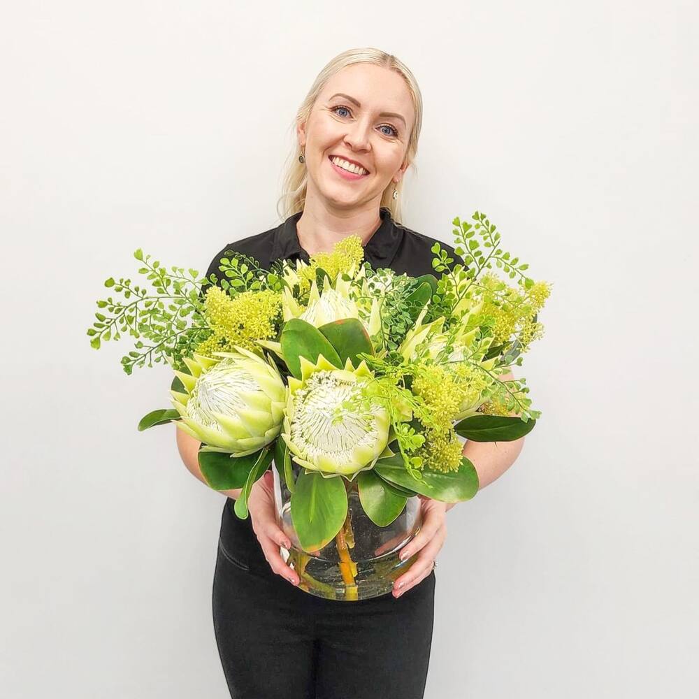 lady holding green flower bouquet