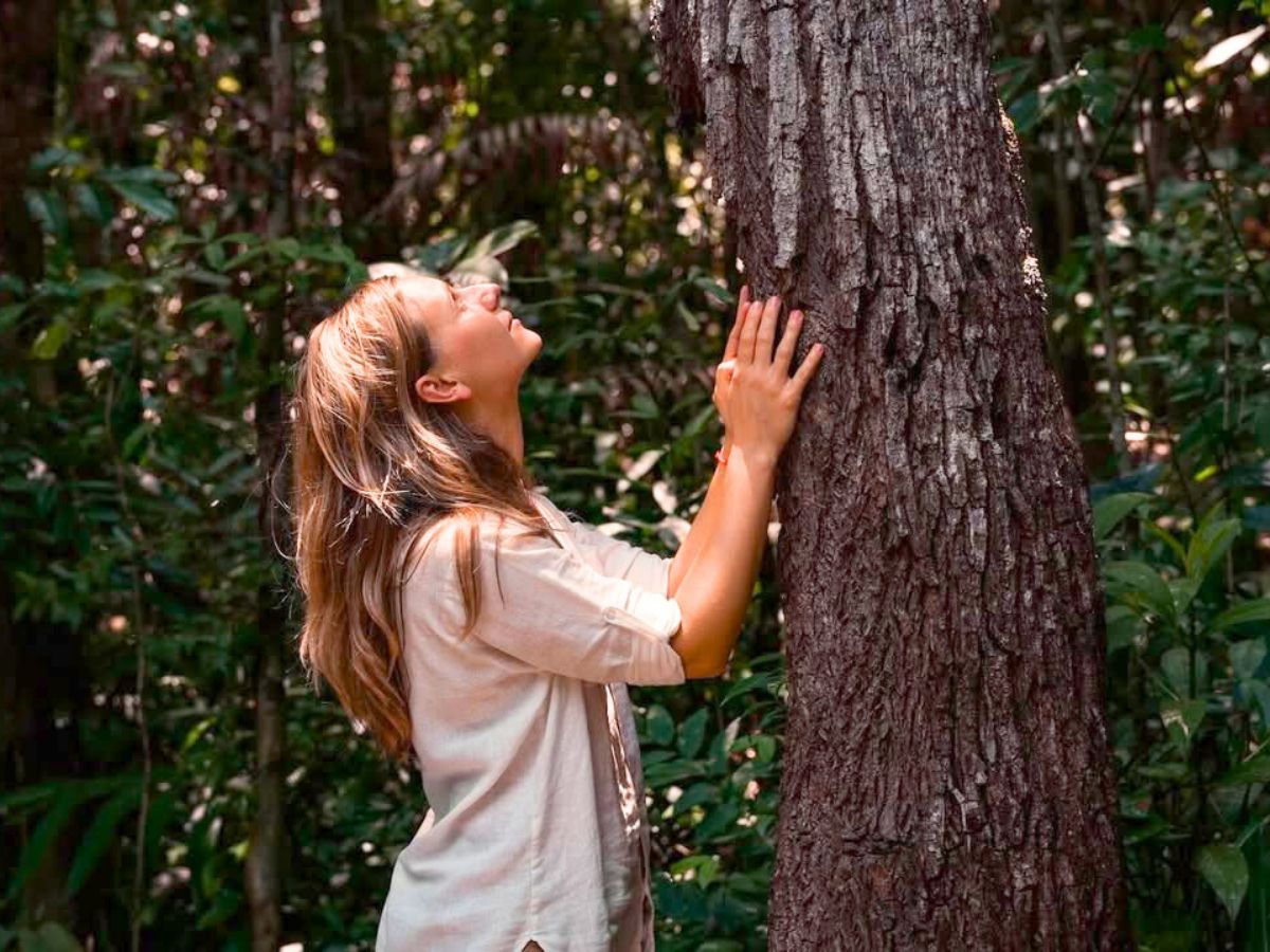 Girl touching a tree in Cambodia