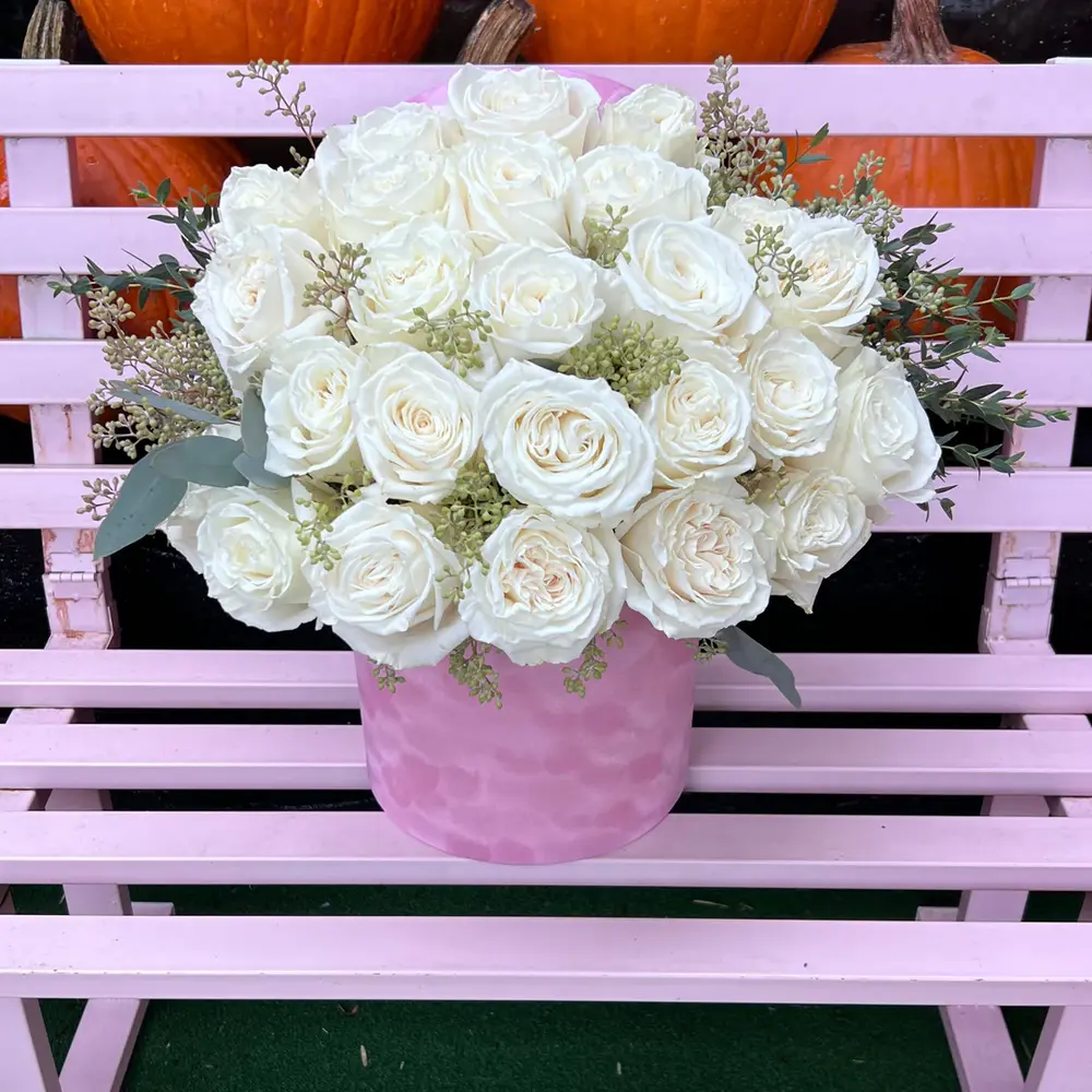 white roses in an elegant box, symbolizing purity and innocence, neatly arranged to create an exquisite gift