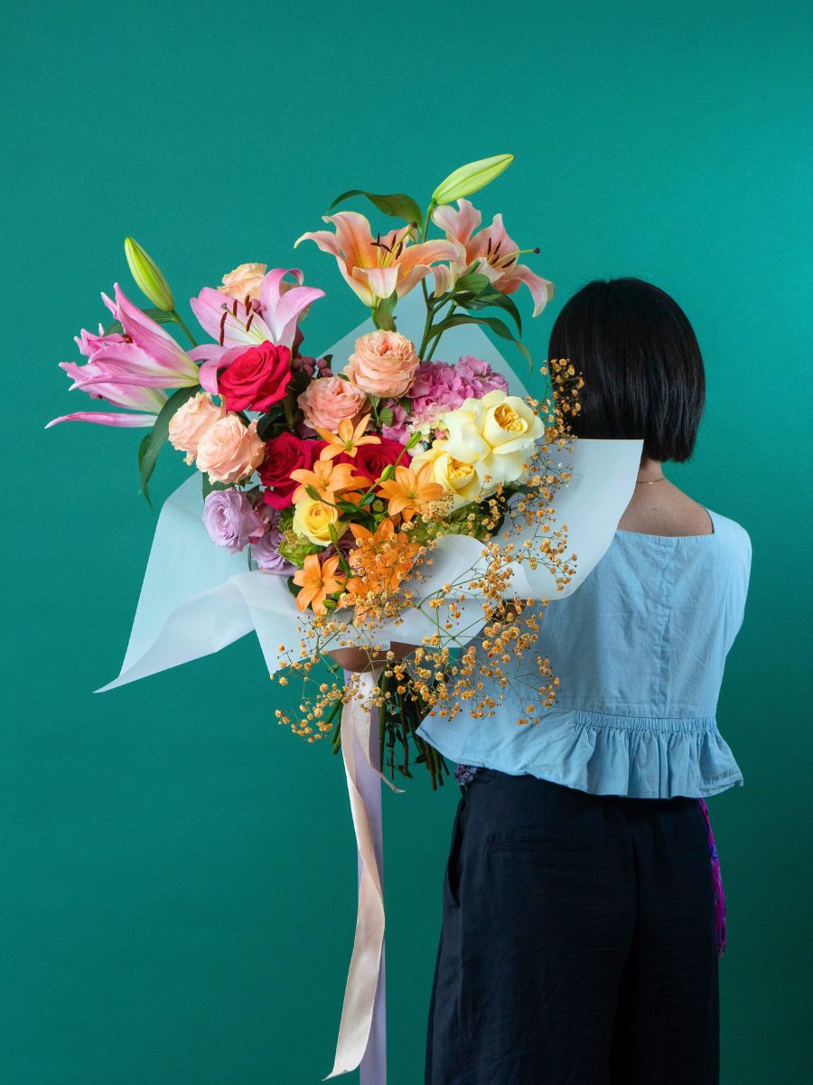 Girl with a gorgeous arrangement by Mystic Flowers