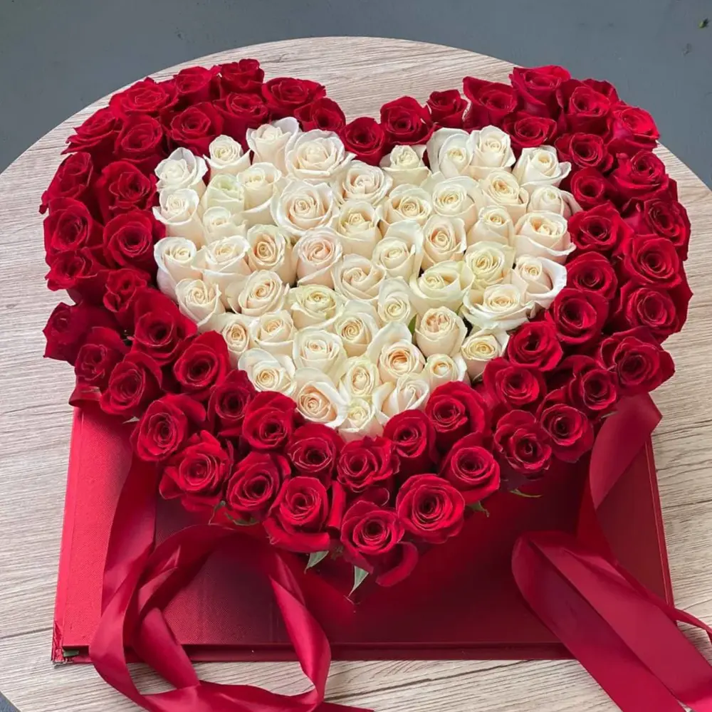 110 red and white roses elegantly placed in a heart-shaped box create a romantic and impressive bouquet, perfect for expressing love and affection