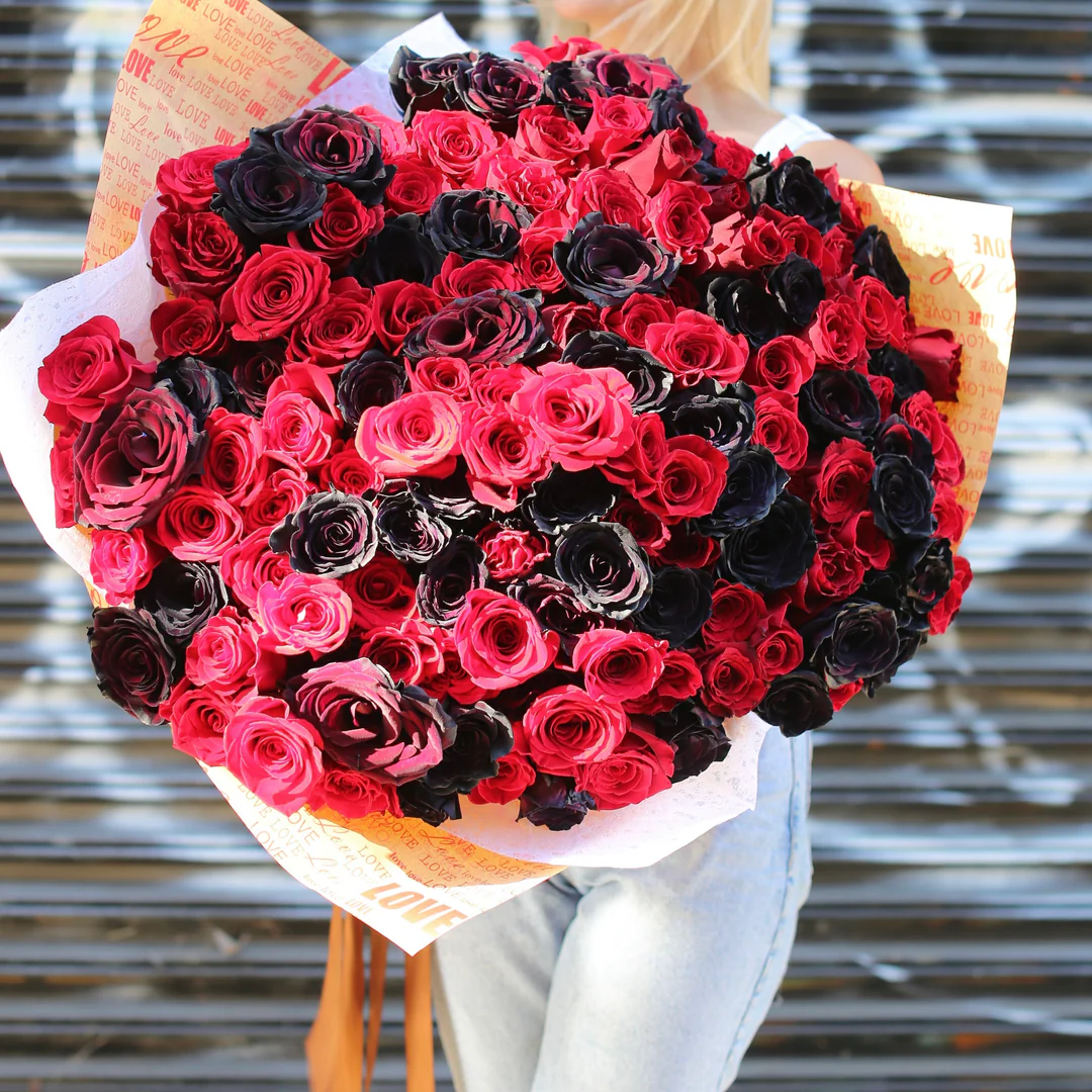 he combination of red and black roses creates a dramatic and striking bouquet that is sure to make a statement