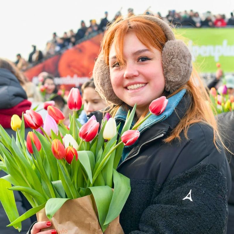 Happy girl with a tulip bouquet