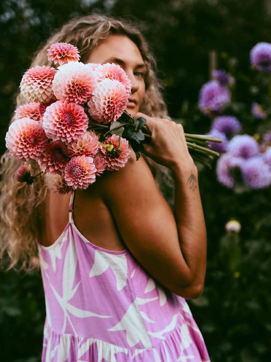 Girl carrying Dahlias in her hand