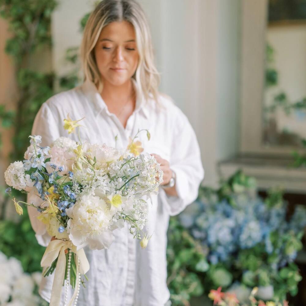 Women holding white bouquet