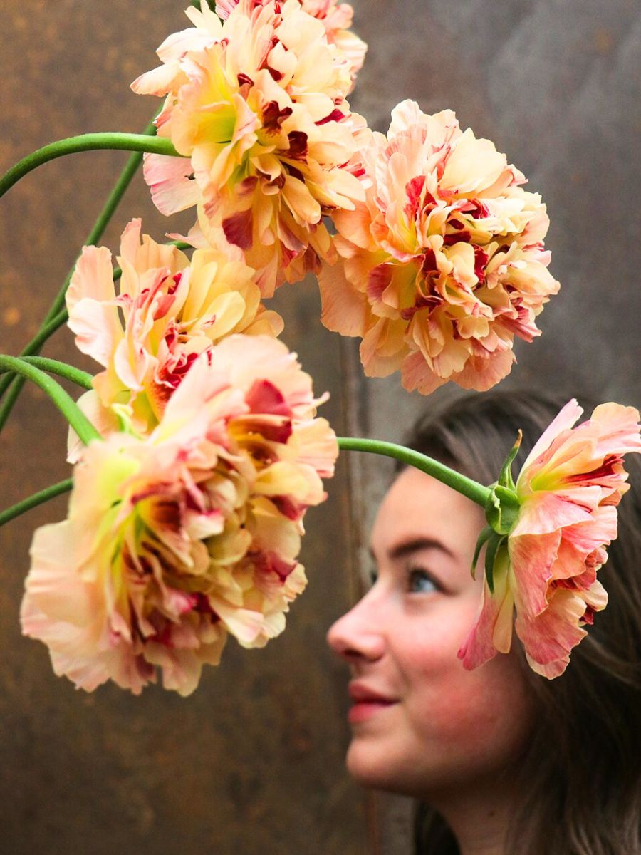 A girl posing with Charlotte ranunculus