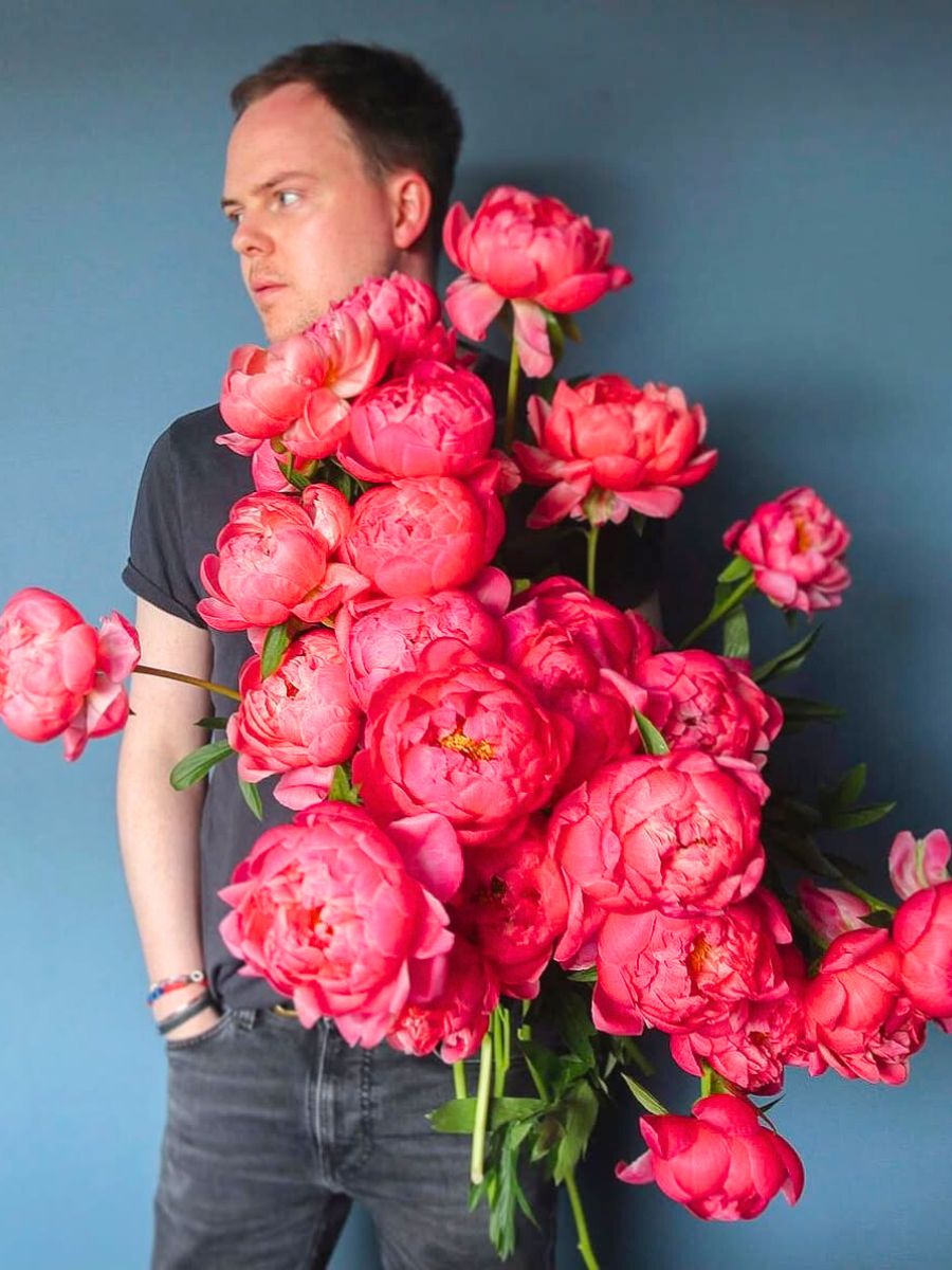 Graeme with bright pink peonies