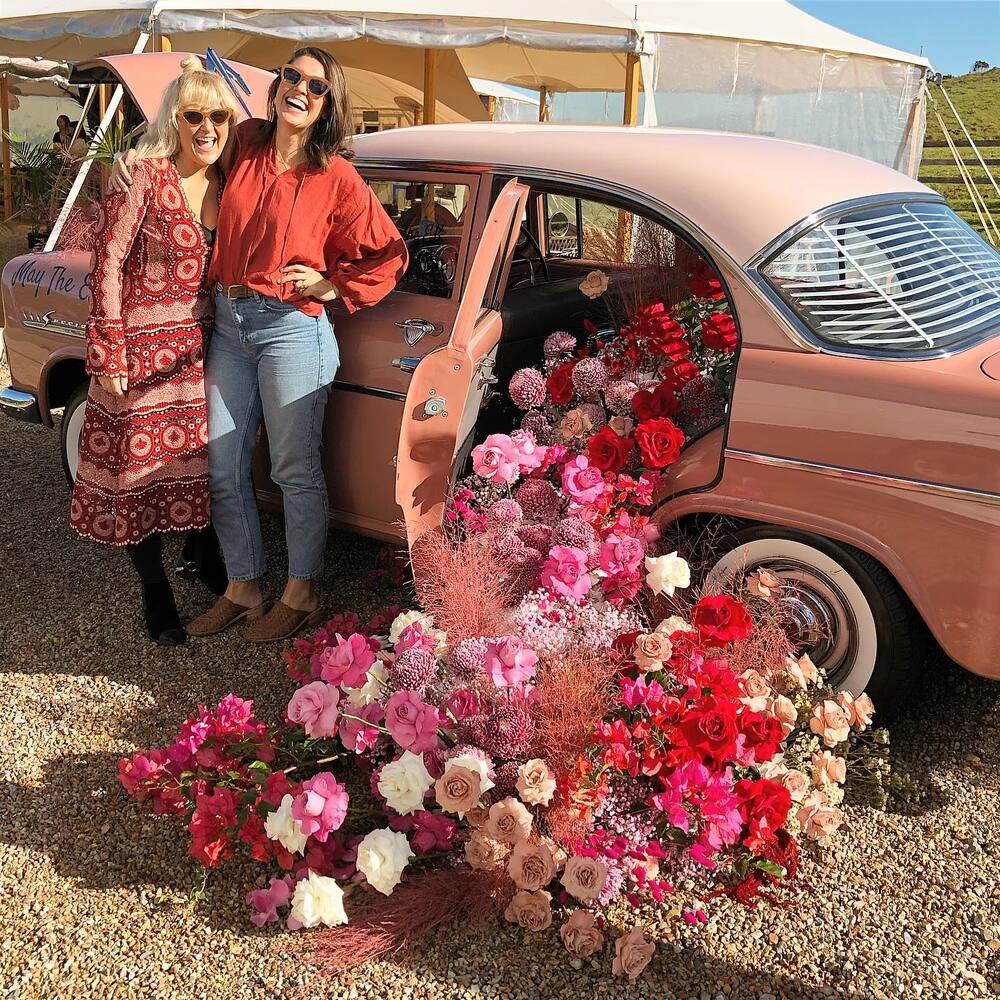 ladies standing near car flower decoration