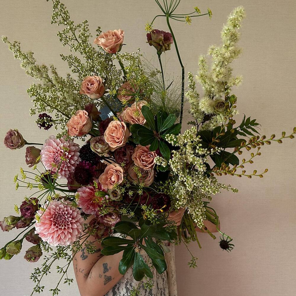 Lady holding flower arrangement bouquet