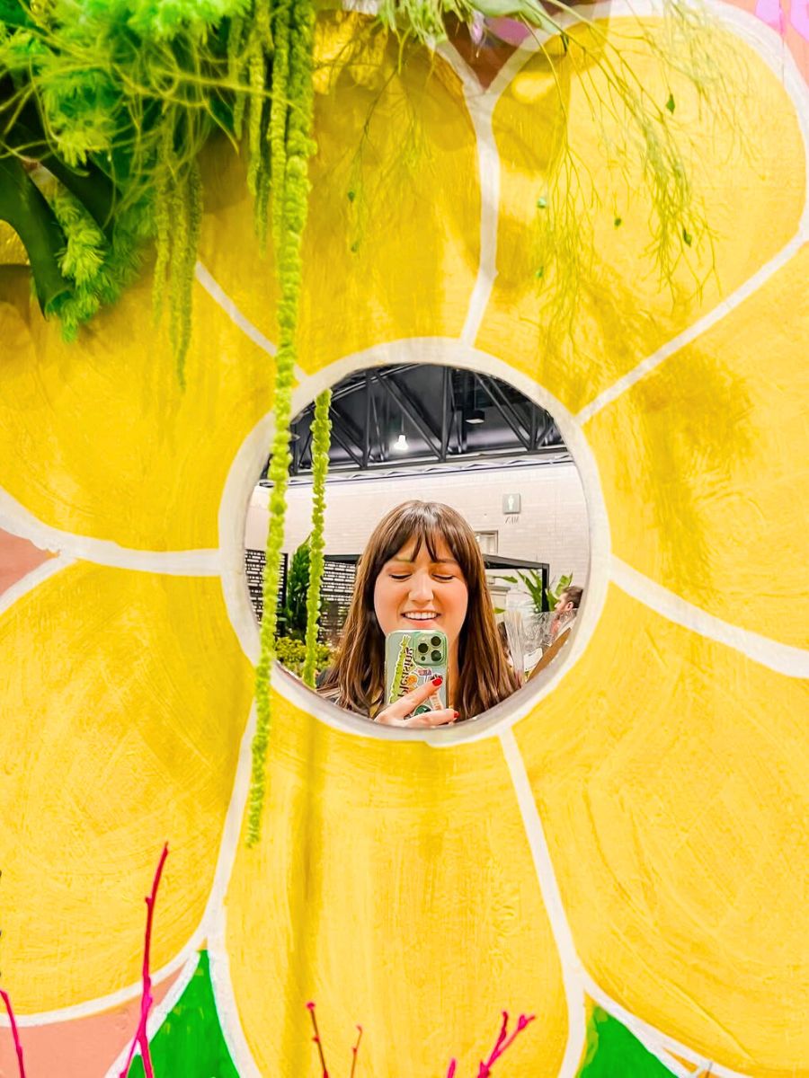 Smiling at a yellow flower booth