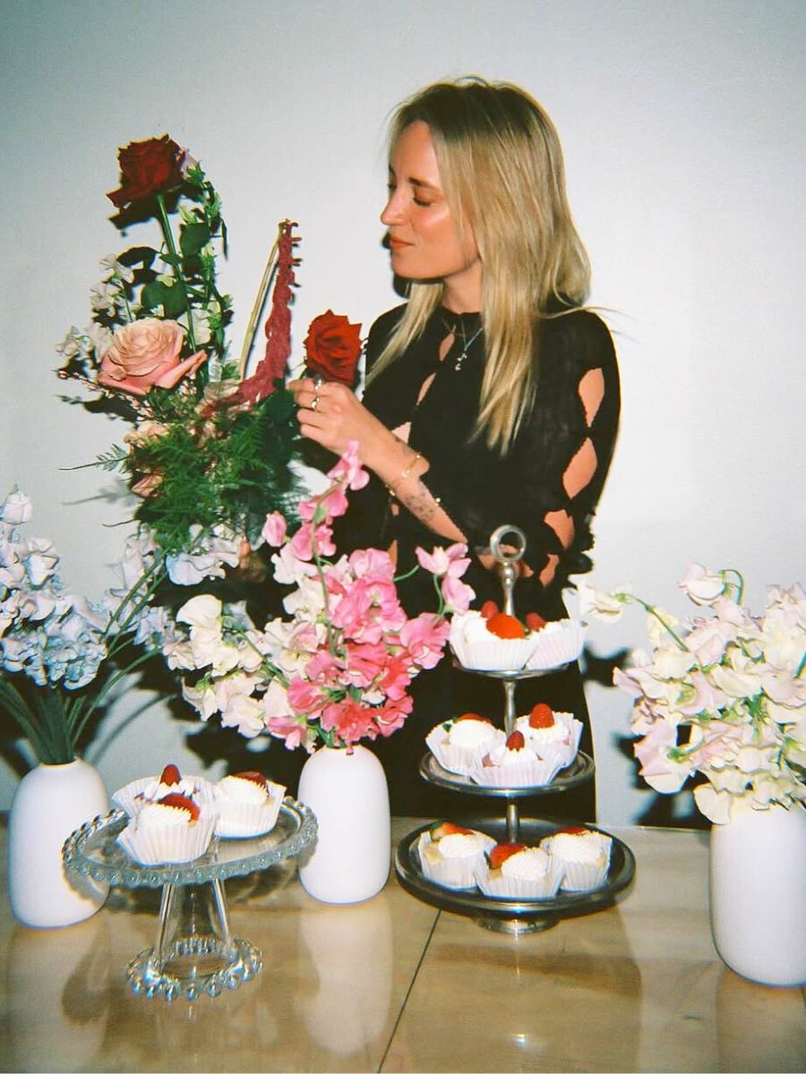 Rachel arranging flowers for a table