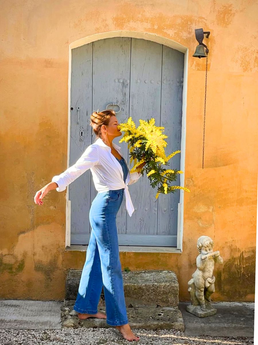 Girl smelling Mimosa flowers