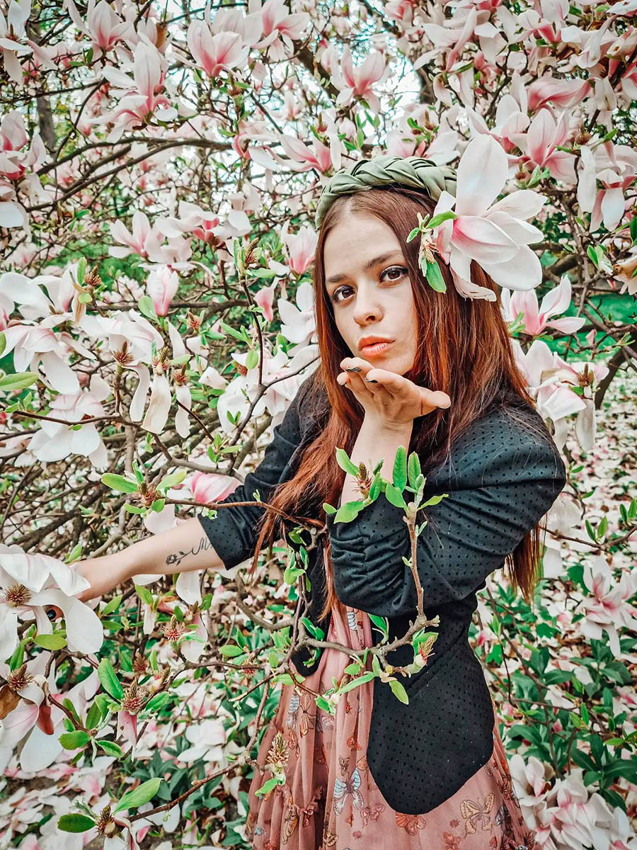 Girl in park with Magnolia Soulangeana