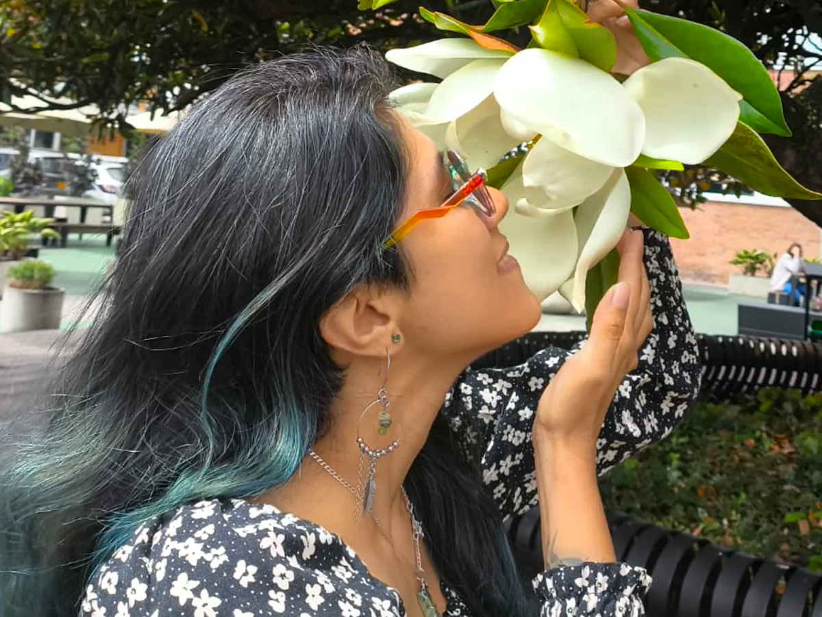 Girl smelling a Magnolia Grandiflora tree