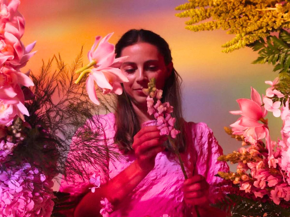 Emily in between pink flowers