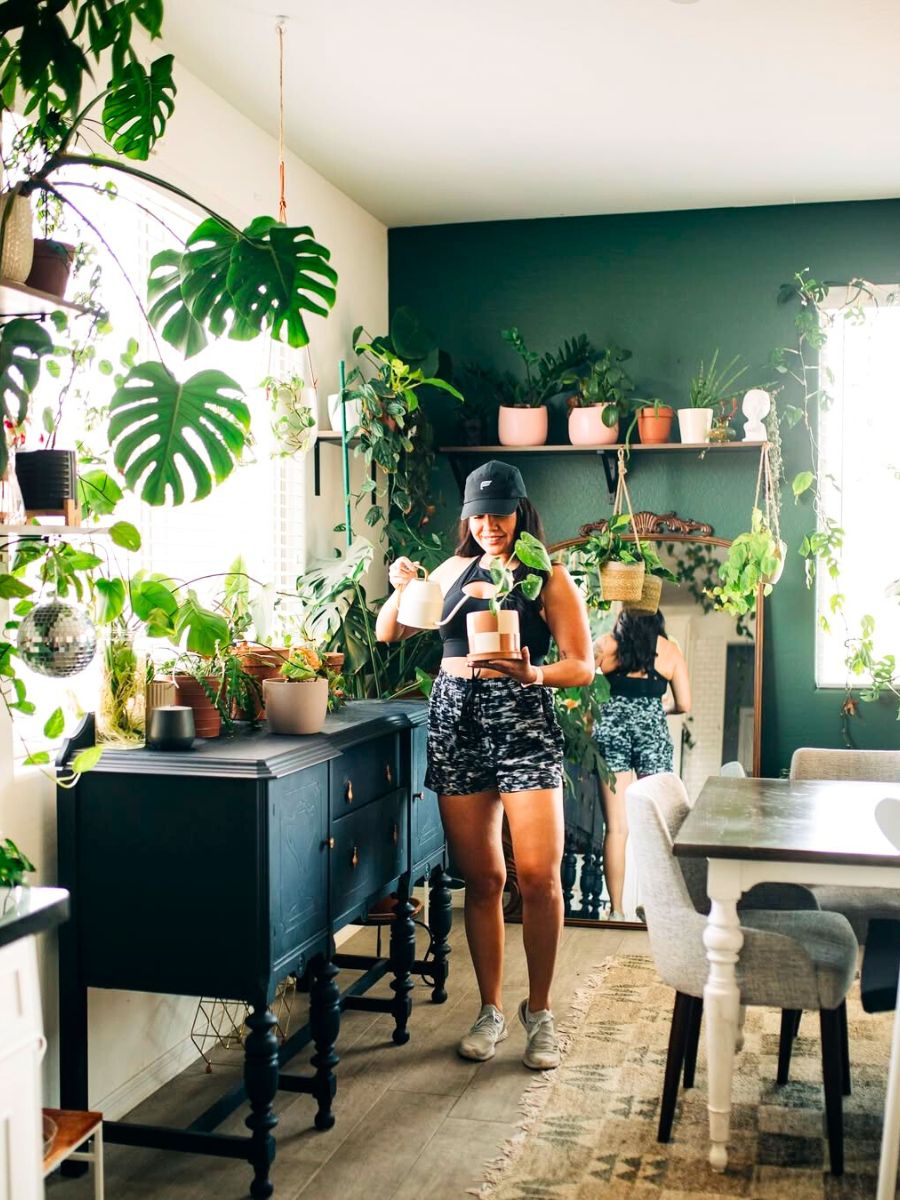 Girl watering her houseplants