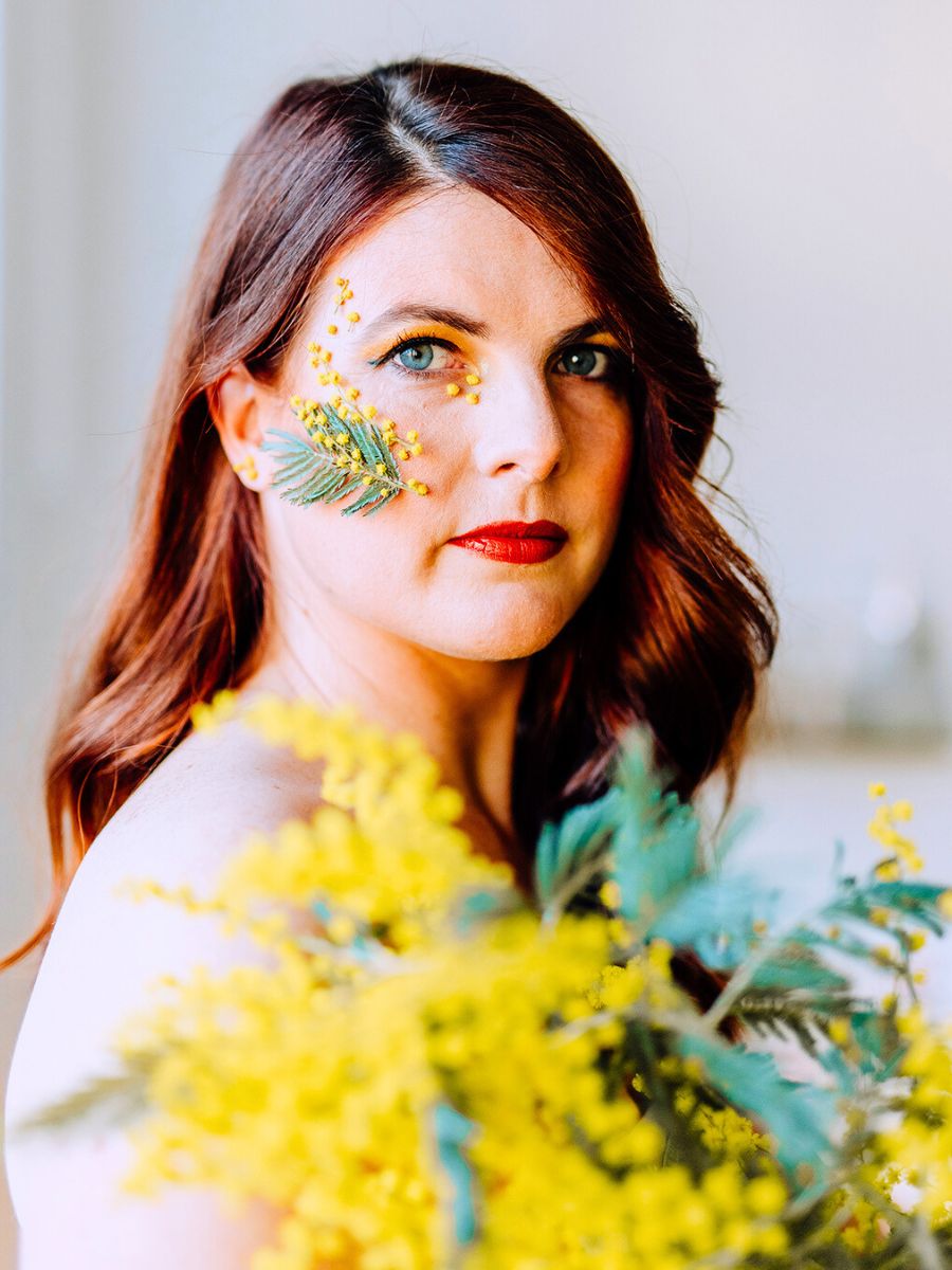 Mimosa flower on womans face