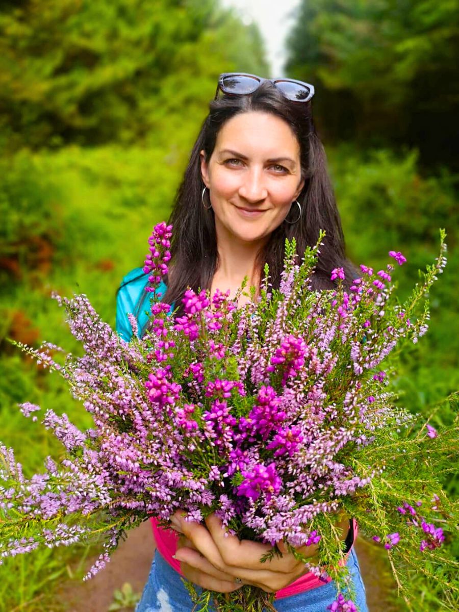 Woman with a bouquet of heather flowers