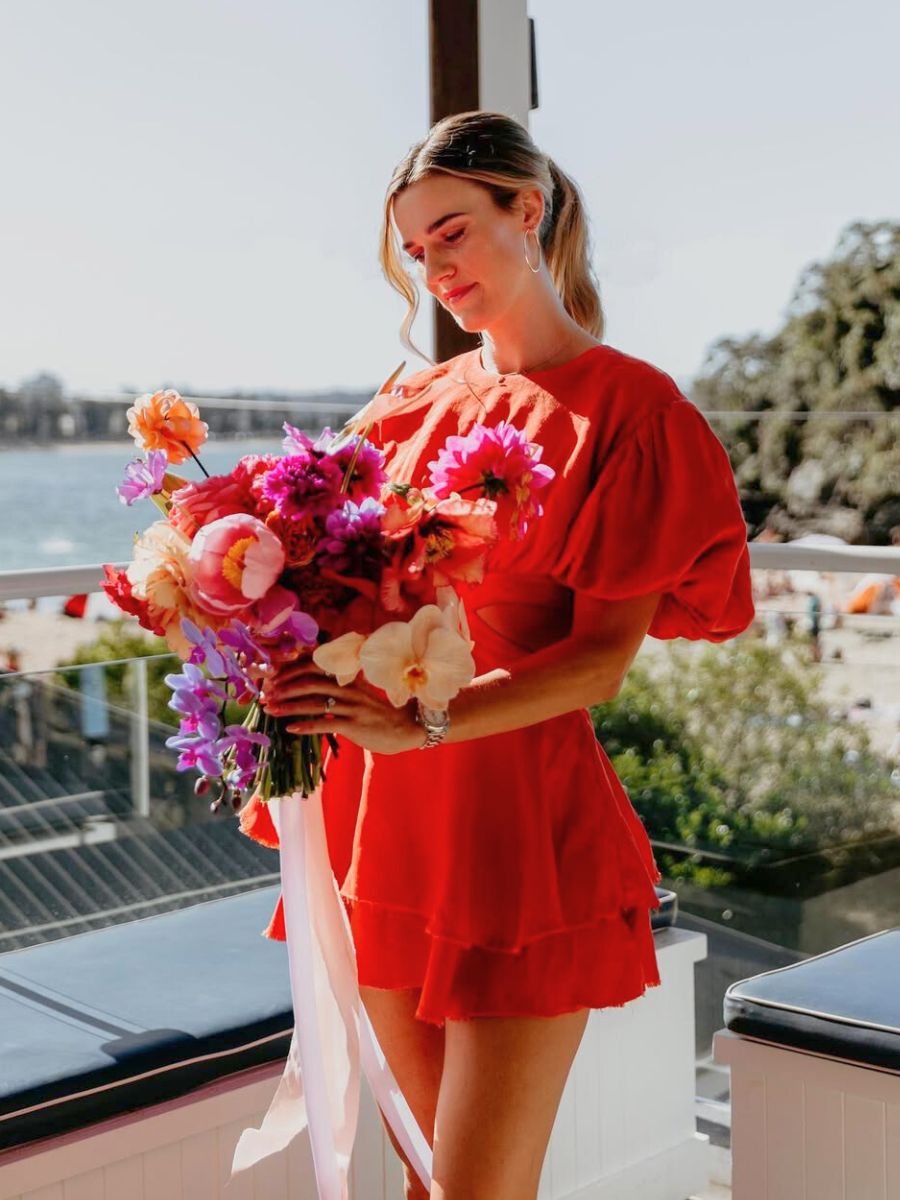 Jess with a red and pink bouquet