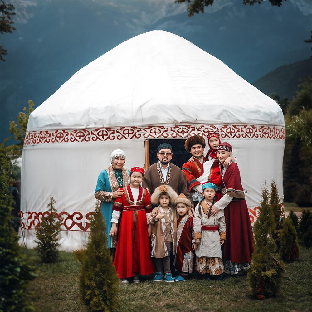 Kazakh family in front of traditonal yurt