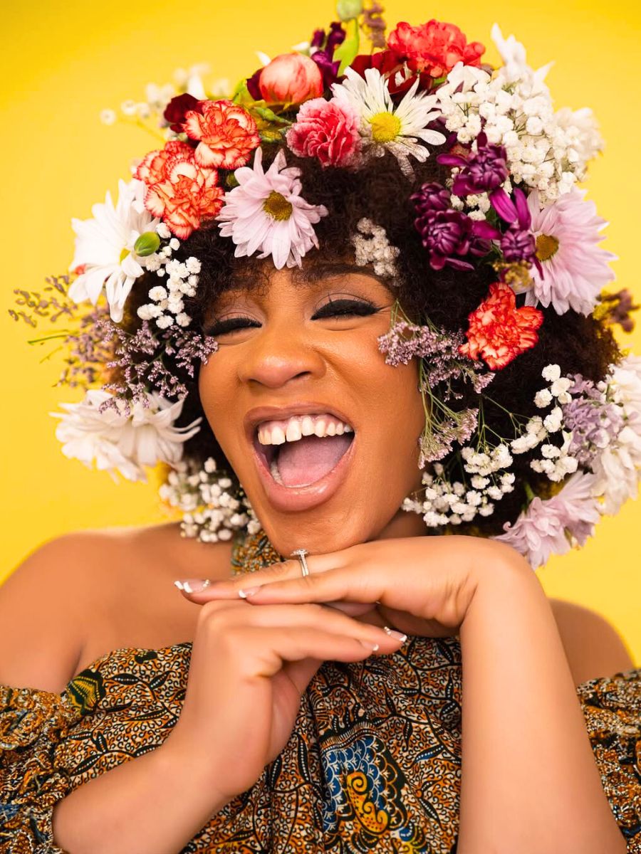 A happy woman wearing a flower headpiece