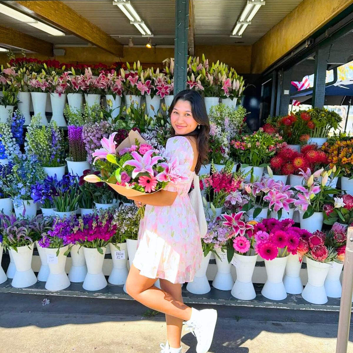 A girl in a flower shop with colorful flowers