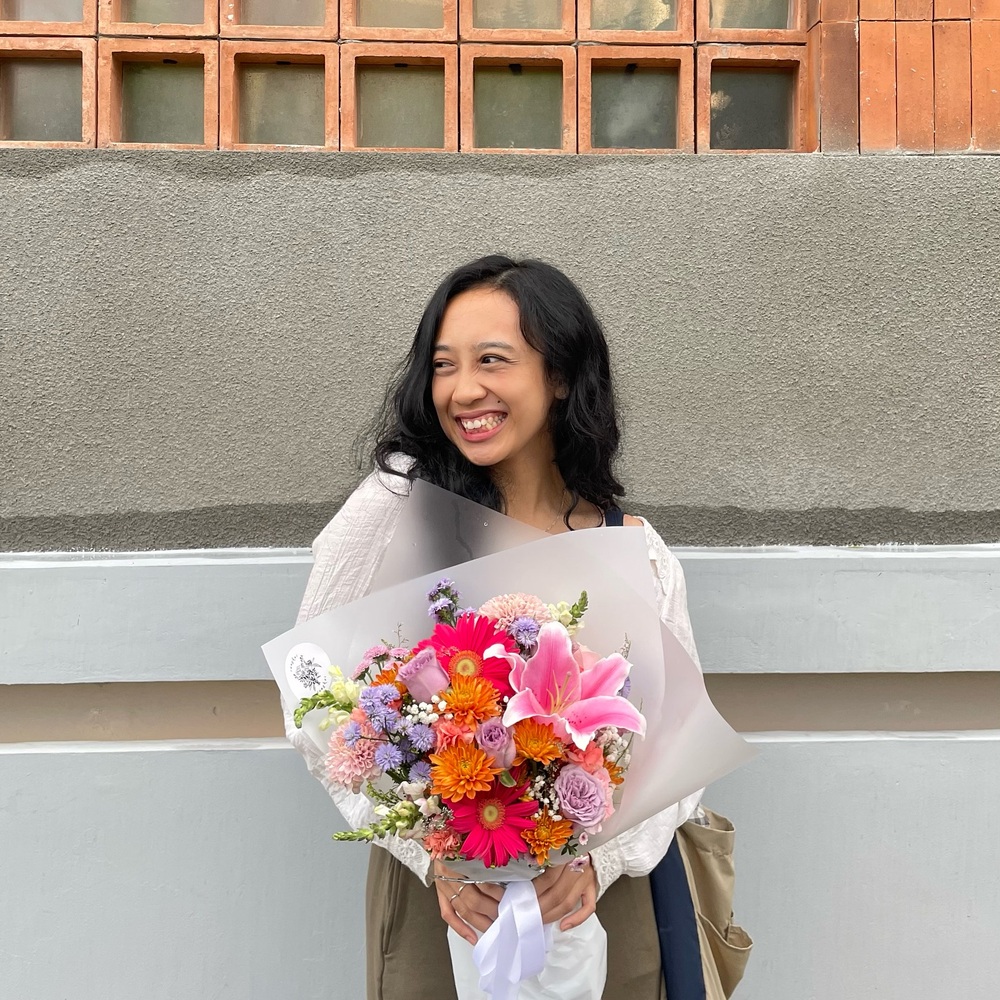 lady standing with flower bouquet