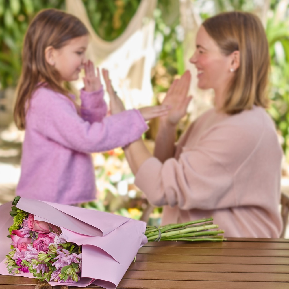 Mom and girl playing around flowers Mom and girl playing around flowers
