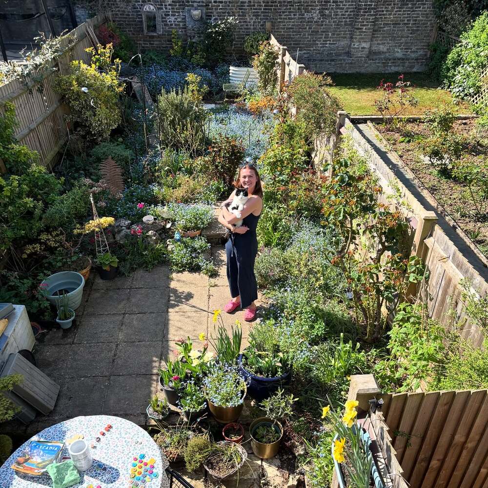 lady standing in center of the garden lady standing in center of the garden