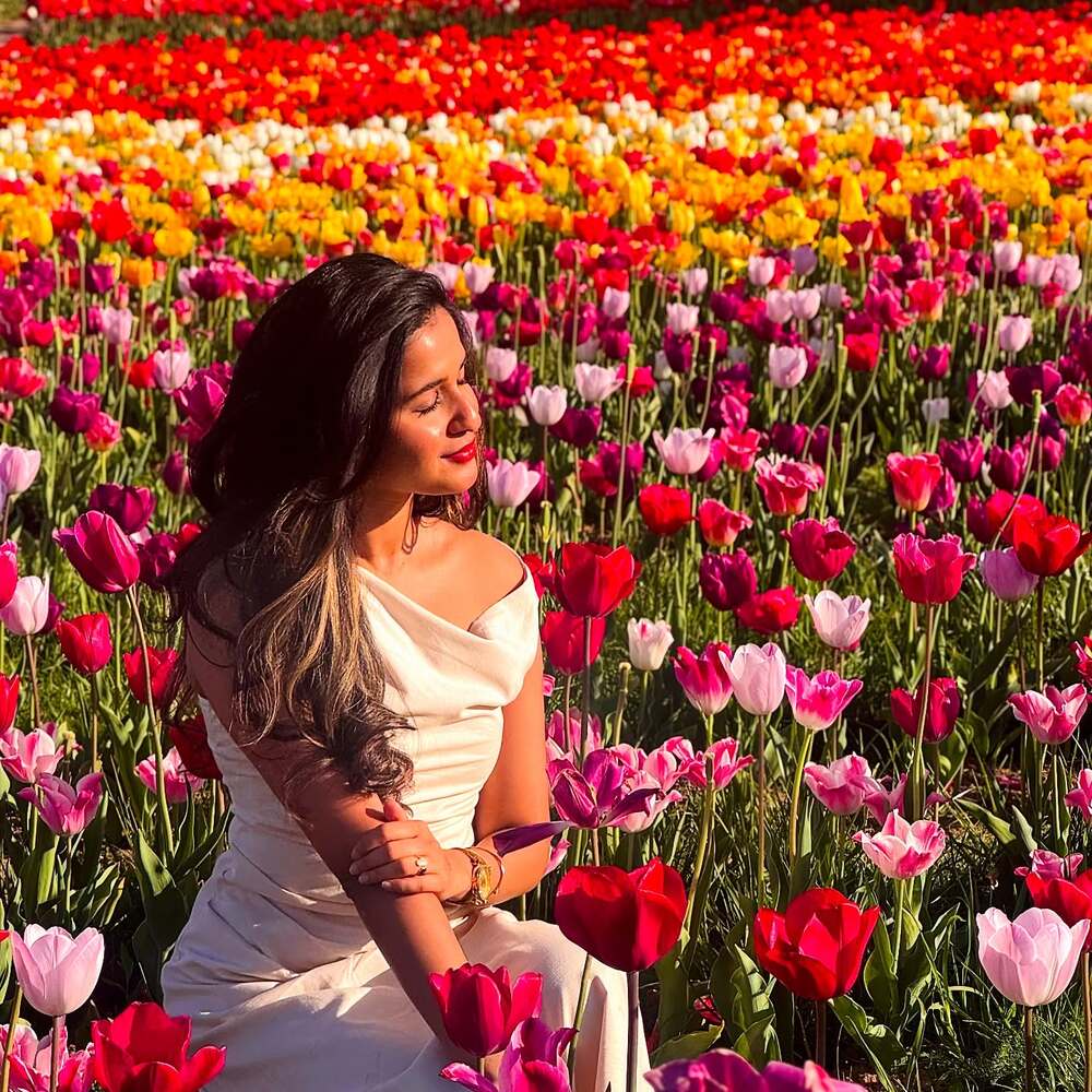 Lady posing for photograph near tulip field Lady posing for photograph near tulip field