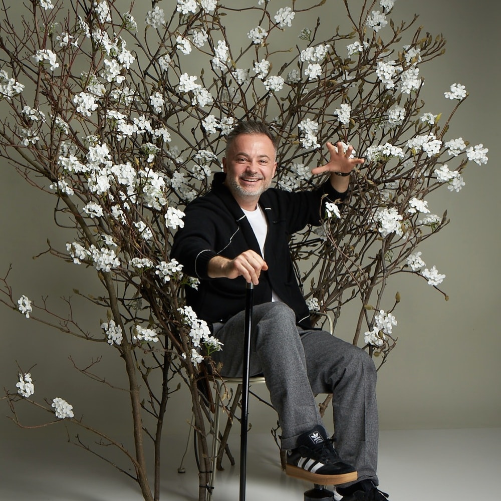 Life of a florist - florist posing with his creation Life of a florist - florist posing with his creation