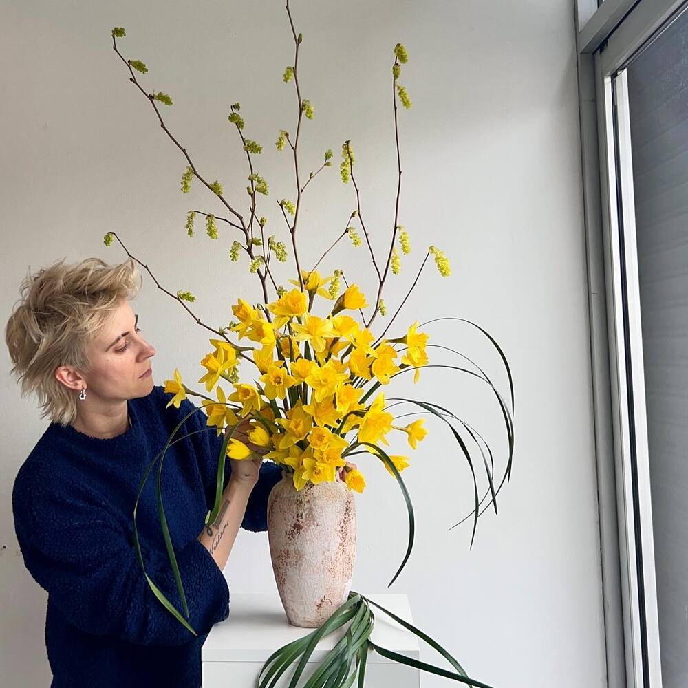 a florist looking at its design closely a florist looking at its design closely